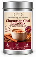 Silver metal canister of Purva's Cinnamon Chai Latte Mix on a white background, displaying the front label with a cup of chai tea. 